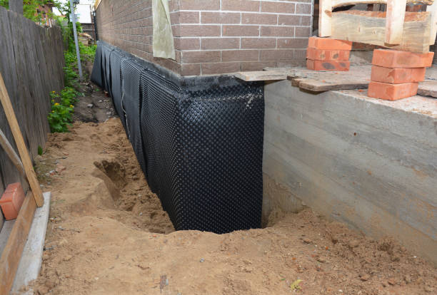 Happy homeowners after waterproofing job in Mays